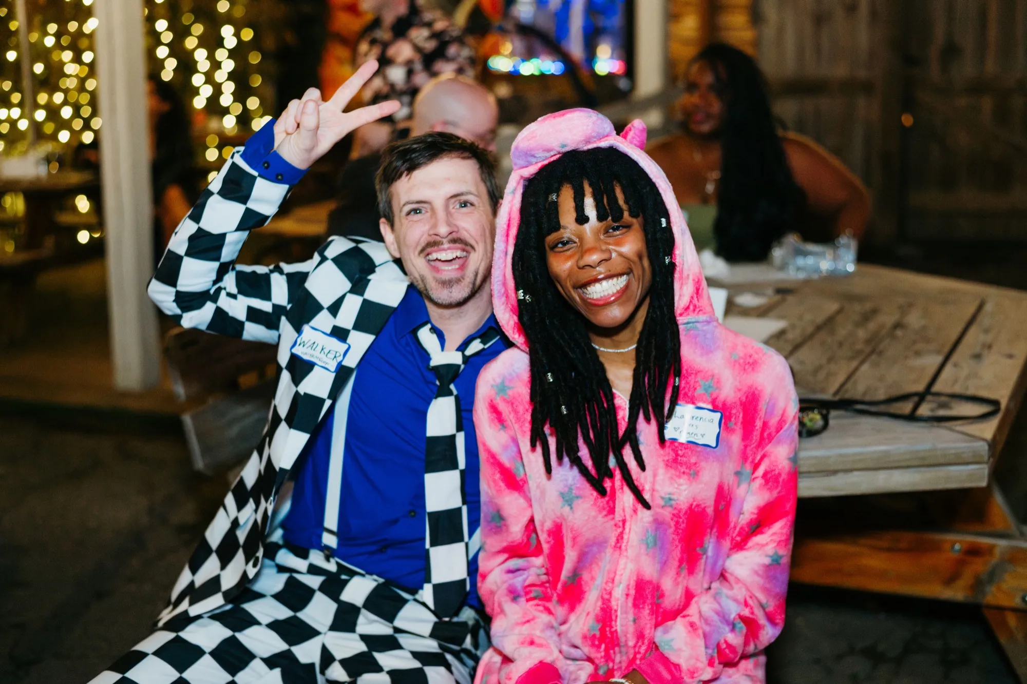 Two members in costume laughing together at an Akta night out